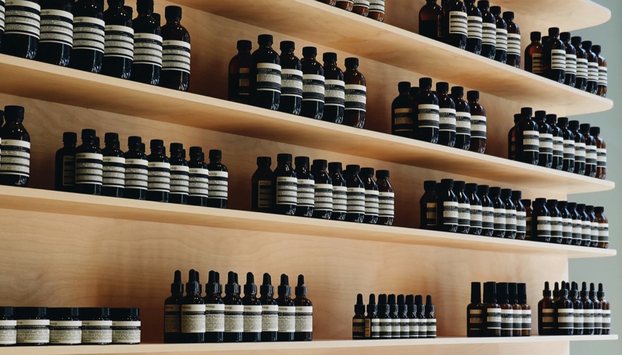 Shelves of amber apothecary bottles in a shop.